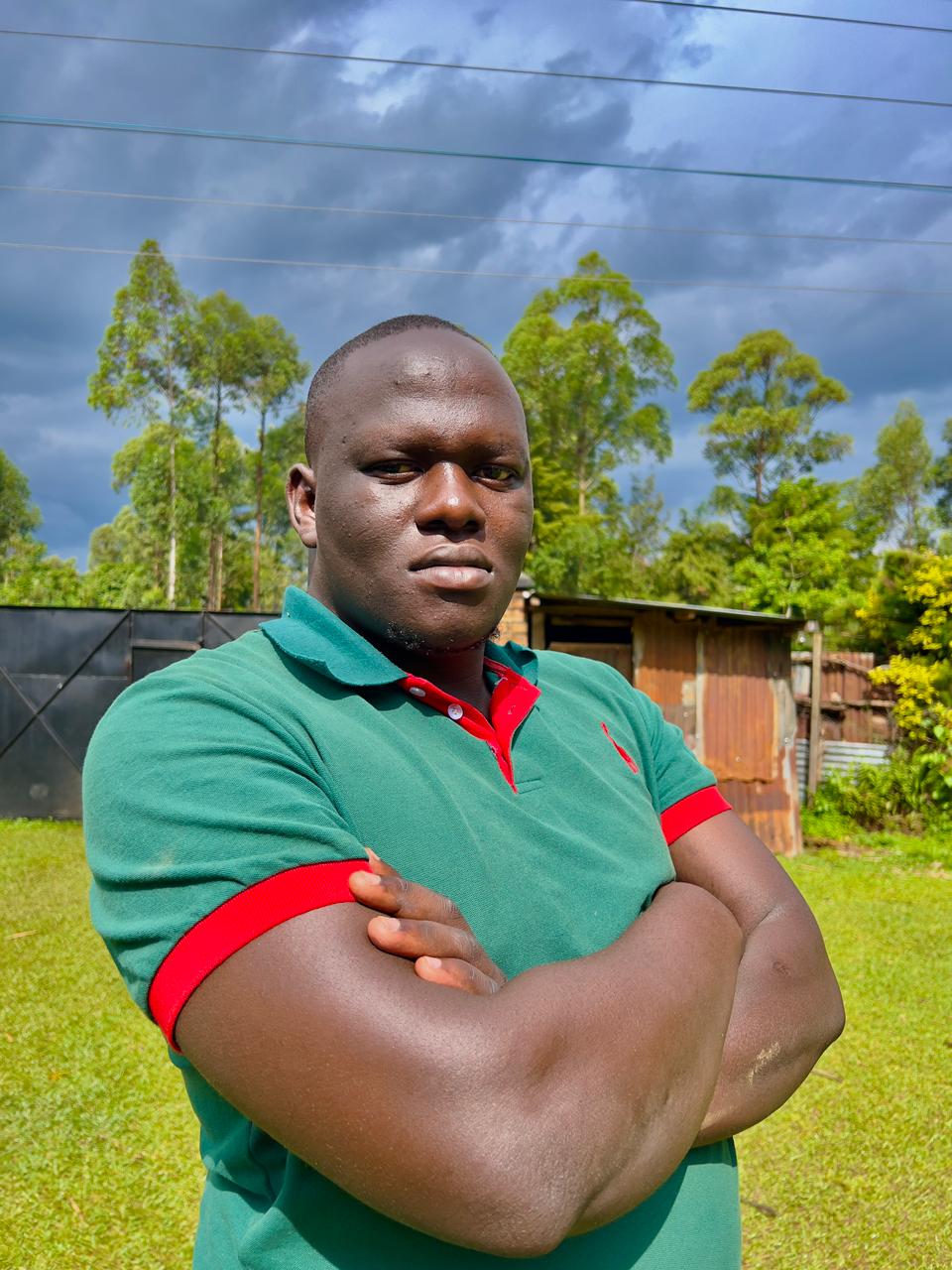 Professional headshot of Gregory Shikutwa, Lead Developer, Graphic Designer & Co-Founder